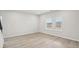 Bedroom featuring light walls, wood flooring, base trim and a double window at 2032 Avalon Rdg, Conyers, GA 30013