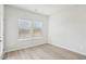 Light-filled bedroom with hardwood floors, white walls, and two windows at 2032 Avalon Rdg, Conyers, GA 30013