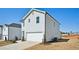Two story home featuring a two car garage, light gray siding and a concrete driveway at 2032 Avalon Rdg, Conyers, GA 30013