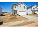 Two story home featuring a two car garage, light gray siding and a concrete driveway at 2032 Avalon Rdg, Conyers, GA 30013