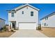 Two story home featuring a two car garage, light gray siding and a concrete driveway at 2032 Avalon Rdg, Conyers, GA 30013