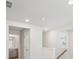 Bright hallway showcasing an entry to bathroom with modern fixtures and neutral color palette at 2032 Avalon Rdg, Conyers, GA 30013