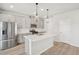 Bright kitchen with stainless appliances, island, and modern pendant lighting at 2032 Avalon Rdg, Conyers, GA 30013