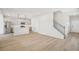Open living space featuring wood floors, staircase and a kitchen with stainless steel appliances at 2032 Avalon Rdg, Conyers, GA 30013