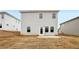 Backyard view of a two-story home with a patio and lawn at 2036 Avalon Rdg, Conyers, GA 30013
