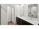 Modern bathroom with dual sinks, dark cabinetry, and a glass-enclosed shower at 2036 Avalon Rdg, Conyers, GA 30013
