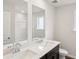 A bathroom with a double sink vanity, large mirrors and white walls at 2036 Avalon Rdg, Conyers, GA 30013