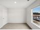Bright bedroom with a large window offering natural light and neutral carpet at 2036 Avalon Rdg, Conyers, GA 30013