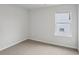 Bright bedroom with a large window offering natural light and neutral carpet at 2036 Avalon Rdg, Conyers, GA 30013