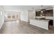 Open-concept kitchen and living area with stainless steel appliances, a kitchen island and wood plank flooring at 2036 Avalon Rdg, Conyers, GA 30013