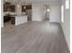 Open kitchen and living area, island with sink, dark cabinets and hardwood style floors at 2036 Avalon Rdg, Conyers, GA 30013