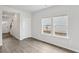 Bright, open-concept living room with hardwood floors, white walls, and large windows for natural light at 2036 Avalon Rdg, Conyers, GA 30013