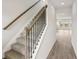 Carpeted staircase with modern wood handrail and black iron balusters leading to the upper level of the home at 2036 Avalon Rdg, Conyers, GA 30013