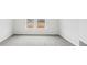 A room painted in a white color with two windows and carpet floors at 2038 Avalon Rdg, Conyers, GA 30013
