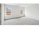 Large room with two windows and gray carpet at 2038 Avalon Rdg, Conyers, GA 30013