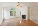 Living room with hardwood floors, fireplace, and large window at 1920 Kolb Farm Sw Cir, Marietta, GA 30008