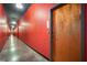 Building hallway with red walls and wood doors at 3400 Malone Dr # 320, Atlanta, GA 30341