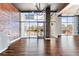 Open living area with hardwood floors, brick accent wall, and large windows at 3400 Malone Dr # 320, Atlanta, GA 30341