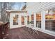 Spacious deck with wooden flooring and white metal furniture set at 2030 Hedge Row, Lawrenceville, GA 30043