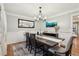 Elegant dining room, featuring a dark wood table and statement art at 2030 Hedge Row, Lawrenceville, GA 30043