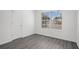 Bright bedroom with wood-look floors and large window at 6876 Wildboar Dr, Fairburn, GA 30213