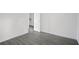 Small bedroom with wood-look floors and door to hallway at 6876 Wildboar Dr, Fairburn, GA 30213