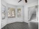 Bright dining area with bay window, wainscoting, and gray vinyl flooring at 6876 Wildboar Dr, Fairburn, GA 30213