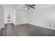 Spacious living room with gray vinyl flooring and access to front entry at 6876 Wildboar Dr, Fairburn, GA 30213