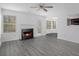 Living room with fireplace, gray vinyl flooring, and access to the back patio at 6876 Wildboar Dr, Fairburn, GA 30213