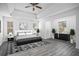 Spacious main bedroom with a ceiling fan and wood-look floors at 6876 Wildboar Dr, Fairburn, GA 30213