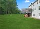 Large backyard with a grassy area, deck and wooded views at 3247 Brigadier Way, Stockbridge, GA 30281