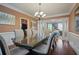 Formal dining room with hardwood floors, chandelier, and a glass-top table at 3247 Brigadier Way, Stockbridge, GA 30281