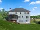Two-story home with gray siding, a deck, and a large backyard at 3247 Brigadier Way, Stockbridge, GA 30281