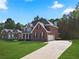 Brick two-story home with a two-car garage and manicured lawn at 3247 Brigadier Way, Stockbridge, GA 30281
