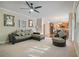 Open Gathering room with hardwood floors, ceiling fan, and views into the kitchen and dining area at 3247 Brigadier Way, Stockbridge, GA 30281