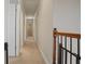 Upstairs hallway with carpeted floors and access to bedrooms and bathrooms at 3247 Brigadier Way, Stockbridge, GA 30281