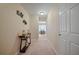 Bright hallway with a console table and carpeted floor at 3247 Brigadier Way, Stockbridge, GA 30281