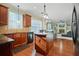 Open kitchen boasts hardwood floors, an island, and a view of the Gathering room at 3247 Brigadier Way, Stockbridge, GA 30281