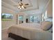 Main bedroom with tray ceiling, large windows, and attached bathroom at 3247 Brigadier Way, Stockbridge, GA 30281