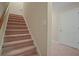 Carpeted stairs leading to the upper level at 3247 Brigadier Way, Stockbridge, GA 30281