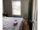 Simple bedroom with a double bed, and window with mini blinds at 114 Muirwood Dr, Temple, GA 30179