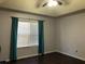 Bright bedroom with teal curtains and dark hardwood floors at 114 Muirwood Dr, Temple, GA 30179