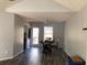 Simple dining room with hardwood floors and access to the back deck at 114 Muirwood Dr, Temple, GA 30179