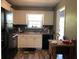 Efficient kitchen with white cabinets, and a window overlooking the backyard at 114 Muirwood Dr, Temple, GA 30179