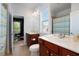 Bright bathroom offers dual sinks, wood cabinets, and a tiled shower with a colorful curtain at 4685 Prater Se Way, Smyrna, GA 30080