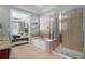 Bright bathroom features a soaking tub, glass shower, and doorway to the main bedroom at 4685 Prater Se Way, Smyrna, GA 30080