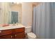 Bathroom features a single sink vanity with storage, a toilet, and a shower with curtain at 4685 Prater Se Way, Smyrna, GA 30080