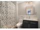 Neutral bathroom offers a pedestal sink, modern hardware and gray-themed geometric shower curtain at 4685 Prater Se Way, Smyrna, GA 30080