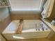 Relaxing soaking tub with tile surround and natural light from the window at 4685 Prater Se Way, Smyrna, GA 30080