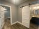Bedroom featuring a sliding barn door, connecting to a modern bathroom and bonus area at 4685 Prater Se Way, Smyrna, GA 30080